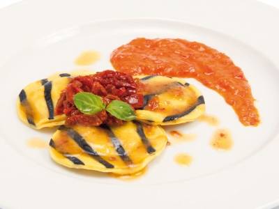 Codfish ravioli with peppers cream and dried tomato fillets