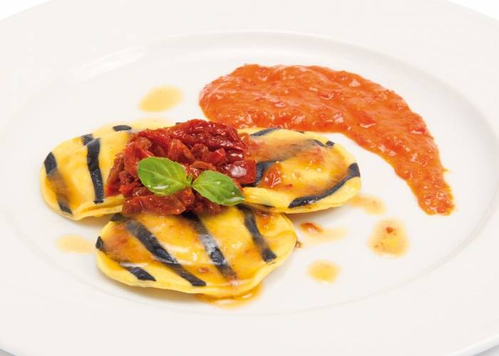 Ravioles de bacalao con crema de pimientos y tomates secos en trozos
